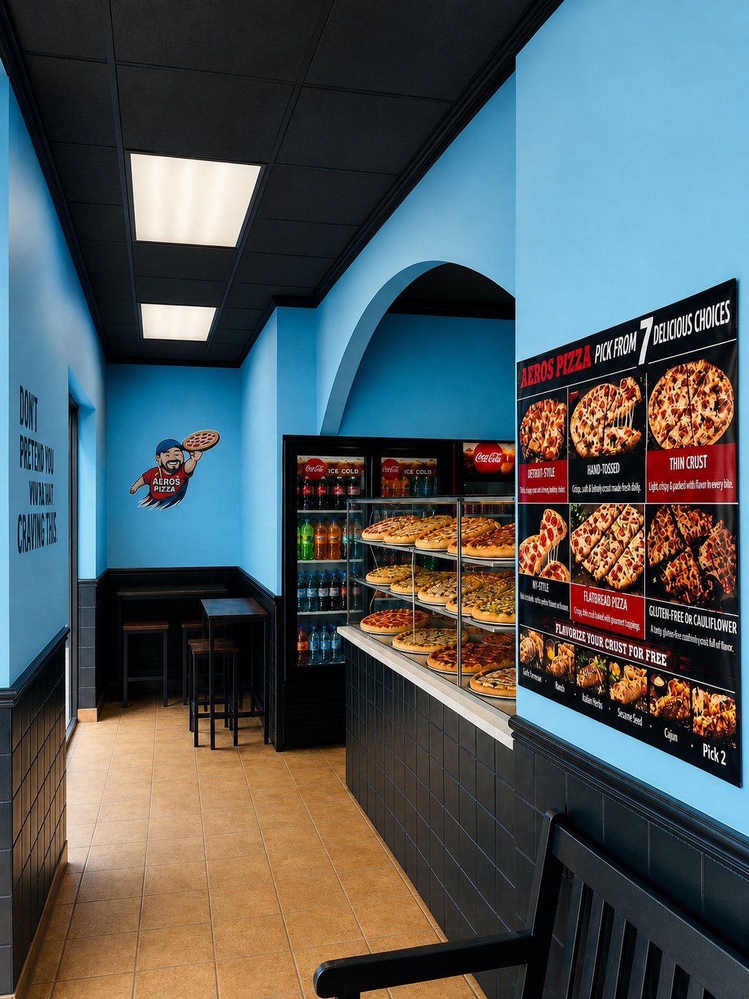Inside Aeros Pizza with blue walls, pizza display, seating, and menu board
